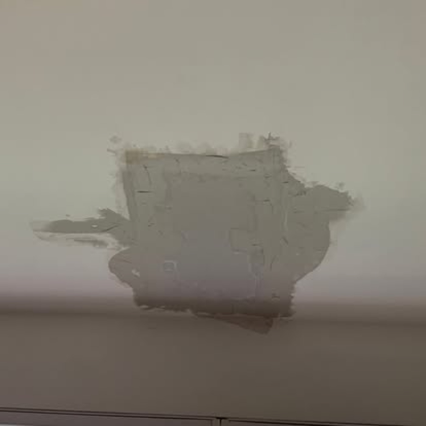 Joint compound applied over the ceiling patch