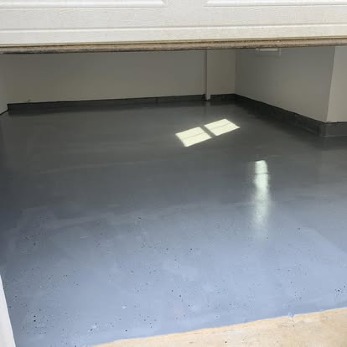 Gray epoxy floor seen from the garage door